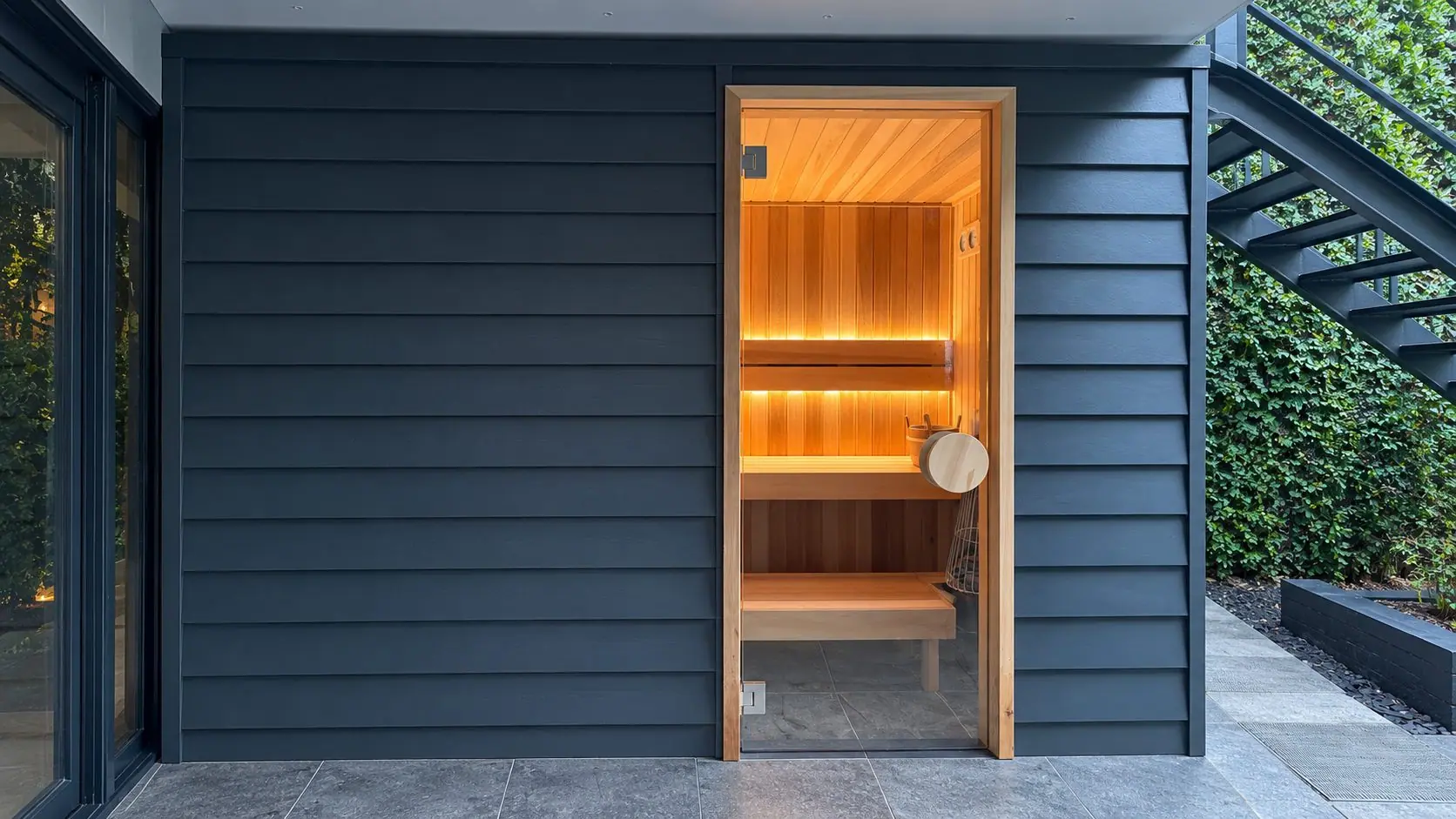 Completed custom sauna with cedar interior and glass entry